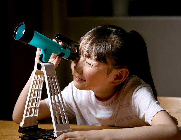 月かんさつ望遠鏡で夜空を観察する女の子